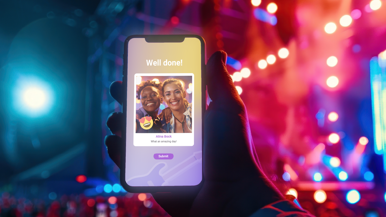 Two friends take a selfie with the Virtual Photobooth during a music festival